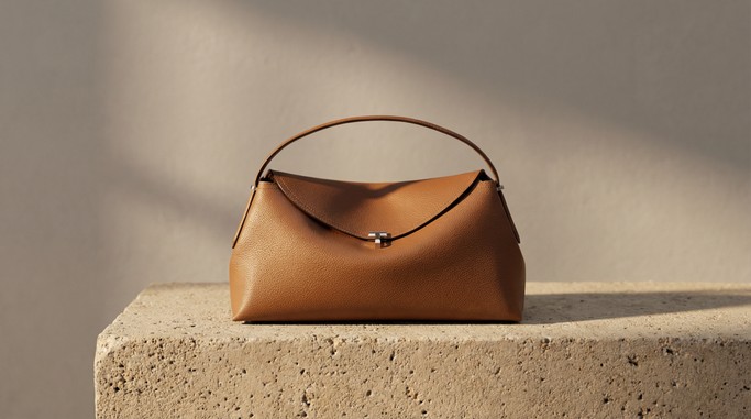 Sunlit straw bag on stone pedestal — example 3 (fashion, AI generation on Cheeppy)