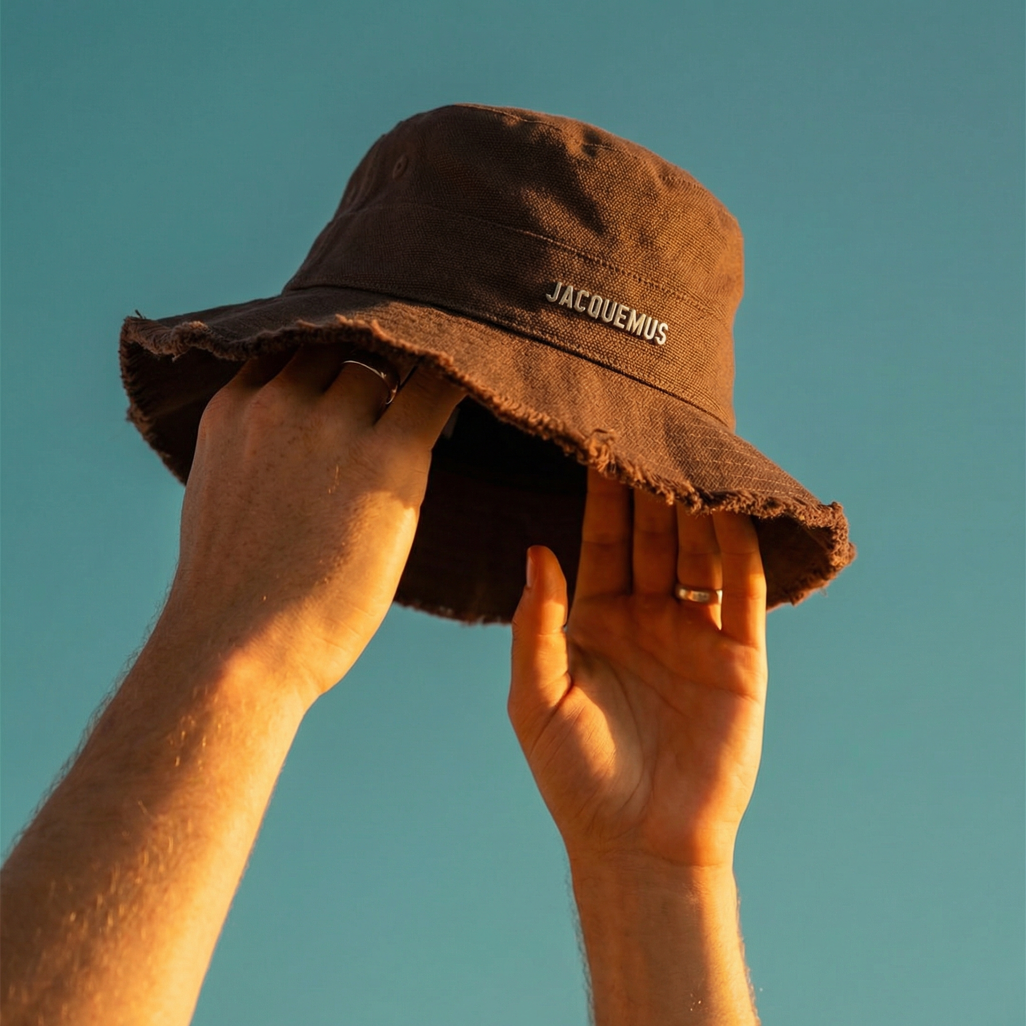 Golden hour bucket cap hero shot — cover image, fashion style by marcovisuals